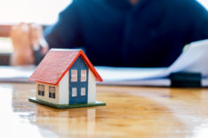 Close-up house model place on table,Behind the blur people are w